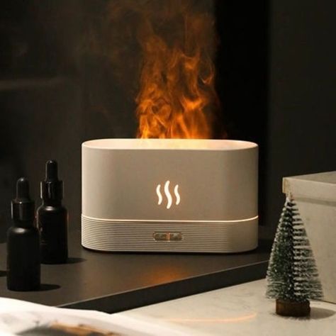 The Flame Aroma Diffuser equips built-in intelligent LED lights and mist to create a realistic flame effect, adding a soothing atmosphere to your home/office/gym. With a compact, convenient, portable design, the flame humidifier is made up of high-quality PP material, a simple button design, and warm ambient light to make the user feel safer and more at ease. Its quiet operation mode offers a peaceful environment to help relieve stress and improve sleep quality. Aromatherapy Humidifier, Air Diffusers, Trending Gadgets, Air Humidifier, Aromatherapy Oils, House Smells, Aroma Diffuser, Essential Oils Aromatherapy, Essential Oil Diffuser