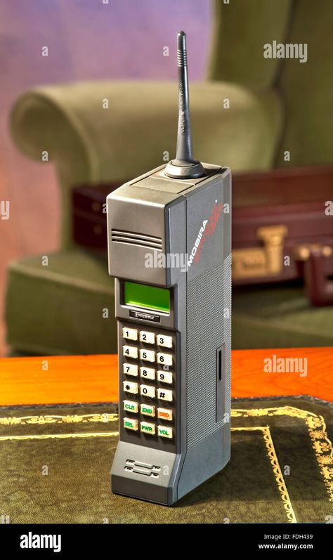 Download this stock image: 1987 Nokia Mobira Cityman 1320 first generation hand mobile cell phone  with 1980's Parker Knoll armchair and 80's business briefcase in background - FDH439 from Alamy's library of millions of high resolution stock photos, illustrations and vectors. 90s Mobile Phone, 80s Telephone, 1940s Phone, 80s Cell Phone, Parker Knoll, Old Landline Phone, Business Briefcase, Technology Fashion, First Generation