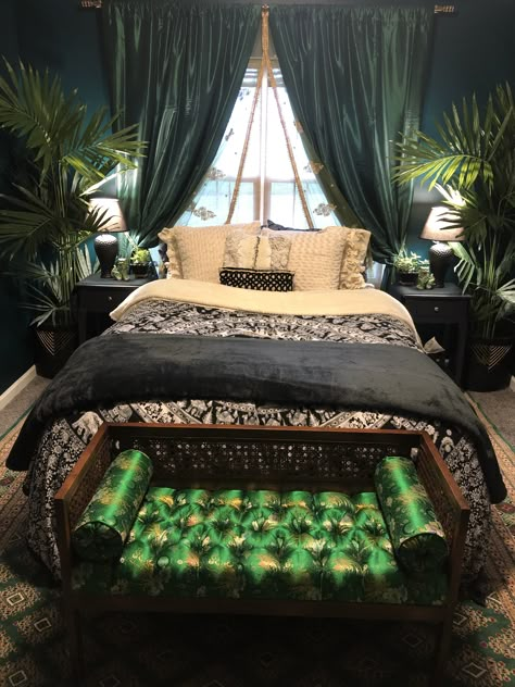 This bedroom was inspired by the lush emerald green color palette. 💚The walls are painted “Sherwood Forest” by Benjamin Moore paints. The emerald green curtains and faux large palm plants flanking the bed are from Overstock. The hand knotted Turkish rug from Etsy. The bench at the end of the bed is an antique store find, we got it for $100 and I found the beautiful green oriental fabric on Etsy, and was able to have it reupholstered. Message me with any questions, I’m happy to answer them! 💚 Emerald Green Boho Decor, Emerald Green Gothic Bedroom, Lush Green Bedroom, Navy Emerald Bedroom, Emerald Glade Bedroom, Viridian Green Bedroom, Emerald Green Decor Bedroom, Emerald Green Wall Paint Bedroom, Forest Green Curtains Bedroom