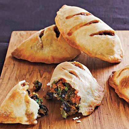 Sweet Potato and Black Bean Empanadas | Mild sweet potatoes and black beans take on smoky, spicy tastes from cumin and chiles. These pies are great served hot at a party; leftovers also make a tasty room-temperature snack. Bean Empanadas, Freezable Recipes, Black Bean Empanadas, Breakfast Empanadas, Potato Empanadas, Sweet Potato And Black Bean, Macro Counting, Freezable Meals, Sweet Potato Black Beans