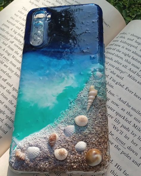 🌊🌸✨ Resin customised beach themed phone cover. #smallbusiness #smallbusinessowner #smallbiz #smallbizowner #resin #resinart #resinartwork #resinwork #resinpour #acrylicpainting #acrylic #watercolor #watercolorpainting #watercolorart #foryou #aesthetic #ａｅｓｔｈｅｔｉｃ Beach Themed Phone, Resin Phone Cover Design, Phone Cover Resin Art, Resin Art Phone Case, Resin Cover Phone, Cute Resin Phone Case, Acrylic Aesthetic, Resin Pour, Resin Artwork