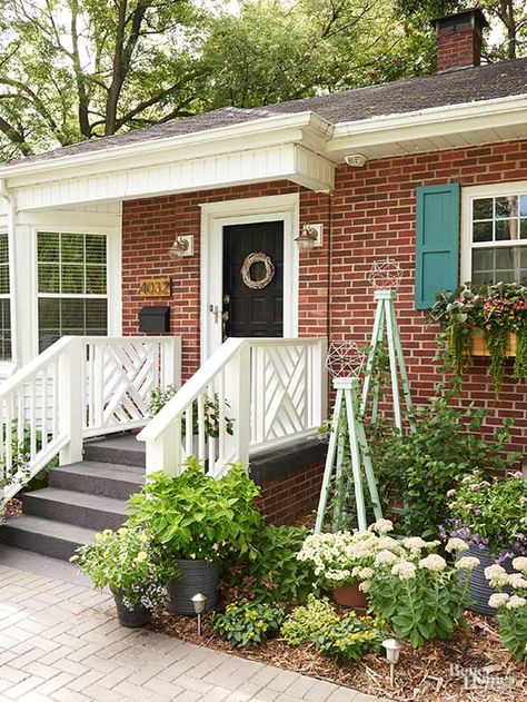 Before the season turns, get a start on boosting your curb appeal. Get inspiration from this done in a weekend DIY front porch remodel. Painted shutters, added flower boxes, a DIY wreath and colorful decor added a welcoming feel to the front of this charming house. Front Porch Remodel, Diy Exterior, Diy Curb Appeal, Painting Shutters, Porch Remodel, Brick Cladding, Building A Porch, Diy Front Porch, Brick Ranch