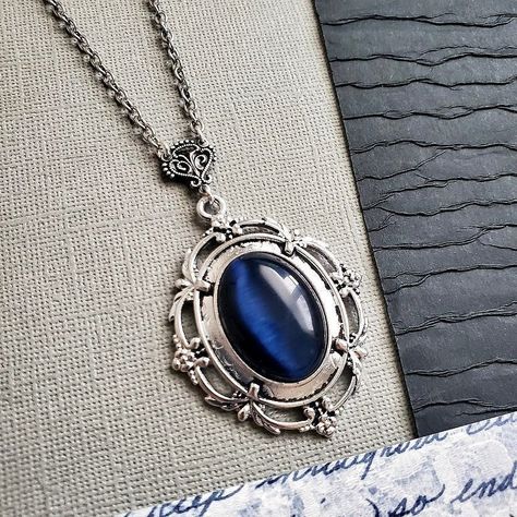 Dark Blue Victorian Necklace About The Blue Stone: ~ Generic Opal Style (Manufactured Stone) About The Pendant: ~ Silver Cast Zinc Alloy ~ 2h x 1.5w inches Chain: ~ Antiqued Silver CHOOSE YOUR CHAIN LENGTH during checkout ☻For ALTERNATE STYLE / ALTERNATE VERSION of this necklace, follow link: https://www.etsy.com/listing/968723211/rich-cats-eye-stone-necklace-opal-style?ref=shop_home_active_1&frs=1 ☻Link to The ENTIRE SHOP: https://www.etsy.com/shop/FashionCrashJewelry?ref=shopsection_shopho Dark Blue Accessories, Chain Neckless, Dark Blue Jewelry, Victorian Pendant Necklace, Turquoise Bar Necklace, Blue Pendant Necklace, Blue Stone Necklace, Victorian Necklace, Stone Ocean