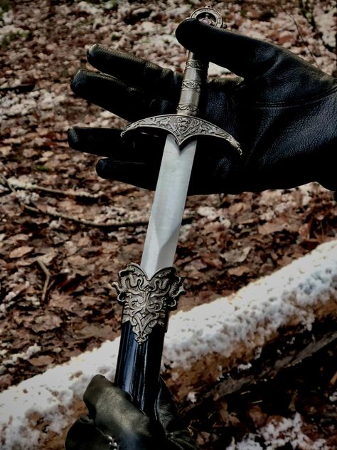 Aesthetically pleasing picture of a dagger being gently pulled from its sheath by a pair of black leather gloved hands. There is a snow covered log in the background. Pretty Dagger, Warlock Dnd, Gloves Aesthetic, Aesthetic Snow, Pretty Knives, Holly Black, Triple Goddess, Cool Knives, Fantasy Novel