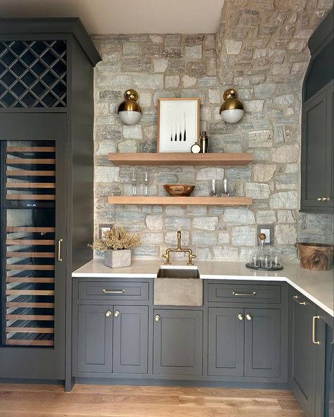 Check out the bar station we built at our Stonehaven spec. The concrete farm sink, the stone backsplash, and the floating white oak shelves create an eclectic combination that comes together beautifully ✨. #homeinspo #interiors #luxuryhomes #luxury #interiordesigner #nashvillehomes #nashvillecontractors #nashvilleconstruction #nashvillelistings #nashvillerealestate #nashvillerealtor #nashvillehomesforsale #luxurylisting #realestate #newconstruction #buildersofig #buildersofinsta #moderninter... Bar With Stone Backsplash, Stone Bar Ideas, White Oak Shelves, Rock Backsplash, Wooden Kitchen Storage, Backsplash With Dark Cabinets, Stone Backsplash Kitchen, Nashville Real Estate, Wood Bar Cart