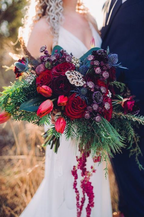 The bride carried a large wintry bouquet of deep reds, greens and jewel tones to match her red lipstick at her winter wedding at 48 Fields in Leesburg, Virginia. #bridebouquet #weddingflowers #jeweltonewedding #winterwedding #modernwedding #virginiawedding Jewel Tone Winter Wedding Flowers, Jewel Tone Cascading Bouquet, Jewel Toned Winter Wedding, Jewel Tone Wedding Winter, Moody Jewel Tone Wedding Flowers, Winter Jewel Tone Wedding, Jewel Toned Bouquet, Winter Jewel Tones, Wedding Winter Colors