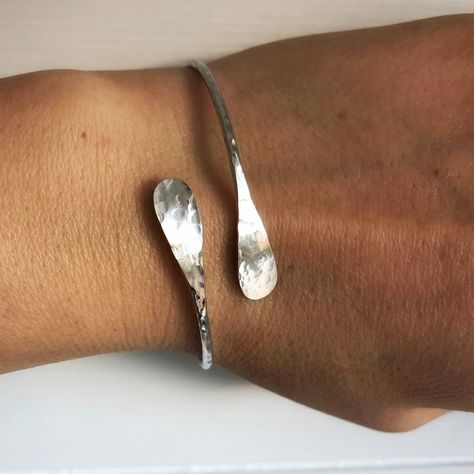 Silver Bangle, Adjustable Hammered Sterling Silver Bangle, Open Crossover Bangle, Solid Silver Bangle, Silver Jewellery uk ------ This sterling silver bangle has been hand crafted using solid 925 eco sterling silver. It adds every day elegance to any look with it's graceful wraparound shape and hammered finish that reflects the light wonderfully. The bangle is adjustable due to the opening and slight flex left in the silver, and comes in 3 sizes given below (approximate diameter) - Please get in touch if you're unsure of which size to order or if you'd like a different size.  Small (6cm) Medium (7cm) Large (7.5cm) ✉️ Customer Review: 'Thank you so much for my beautiful bangle, its stunning! I'll be ordering more from you in the future' Fantasy Earrings, Wrap Bangles, Bangle Silver, Sterling Silver Bangle, Dope Jewelry, Hammered Sterling Silver, Jewellery Uk, Funky Jewelry, Sterling Silver Bangles