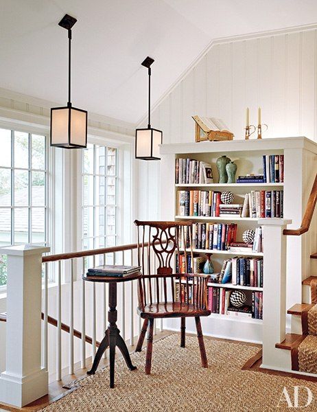 In a Hamptons home renovated by architect Andrew Pollock and furnished by Cullman & Kravis, a new stair landing created space for a reading nook. The elmwood comb-back Windsor chair dates from the 1780s, and the candlestick table is from the late 19th century. The sisal carpet and runner are from Beauvais. Top Of Stairs Landing Decor, Stairs Landing Decor, Stair Landing Decor, Landing Decor, Top Of Stairs, Stair Landing, Hamptons House, Cozy Reading Nook, Sisal Rug