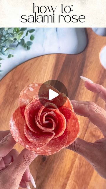 Kim Charon | Charcuterie & Things LLC on Instagram: "DIY: SALAMI ROSES 🌹 

Tools: 2oz condiment cup and 11 salami slices

Layer: Place 5 slices halfway over the first one around the cup. 

Create the bud: Fold 6 slices of salami in half with the rounded side up. Layer the folded slices on top of the other right to left. 

Roll: Start rolling from one end to the other, securing the base as you go.

Finish: Gently spread the “petals” to create a rose shape.

PRO TIP: Mix and match different types of salami for added texture and flavor. 🌟

SAVE and FOLLOW @charcuterie_n_things for more cheese and charcuterie food styling tips!

#charcuterie #foodstyling #cheese #grazingtable #partyplanning #fooddesign #longisland #fyp #charcuterieandthings #easyappetizers #quickandeasy #CheeseBoard #Charcut Charcuterie Board Ideas Salami Rose, Cheese Slices Charcuterie, How To Fold Meet For Charcuterie, Rose Meat Charcuterie, Prosciutto Rose How To, Cheese Flowers Charcuterie, Rose Salami Charcuterie, Folding Salami, Salami Flower Charcuterie