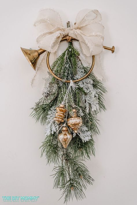 DIY Christmas Door Swag with a Thrifted French Horn | The DIY Mommy Diy Victorian Christmas, French Horn Decorating Ideas, Door Swags, Decorating With Nutcrackers, Simple Christmas Wreaths, Evergreen Swags For Christmas Diy, French Horn Wreath, Diy Christmas Swag, Christmas Horn Decor