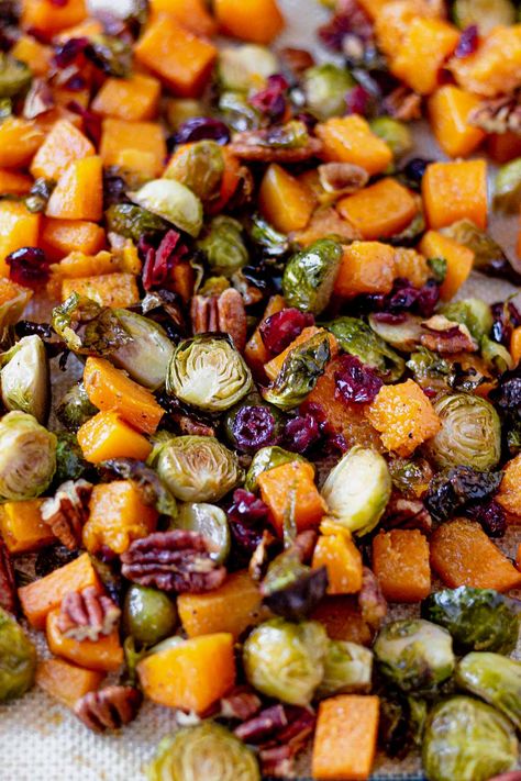 Roasted brussel sprouts and butternut squash are coated with a sweet maple glaze and tossed with toasted pecans and sweet dried cranberries. This healthy side dish is a great gluten free and dairy free option for Thanksgiving. Butternut Squash Beets Brussel Sprouts, Maple Soy Glazed Roasted Brussels Sprouts And Butternut Squash, Butternut Squash Brussel Sprouts Roasted Maple, Cranberry Glazed Roasted Butternut Squash Brussel Sprouts Goat Cheese, Maple Roasted Butternut Squash And Brussel Sprouts, Vegan Thanksgiving Brussel Sprouts, Roasted Brussel Sprouts And Butternut Squash With Balsamic, Brussel Sprouts With Butternut Squash Balsamic Glaze, Maple Roasted Brussel Sprouts With Sweet Potatoes