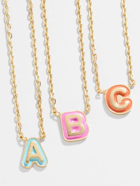 Our 18K Gold Enamel Bubble Initial Necklace gives the classic initial necklace an updated spin. A tiny gold letter of your choice sits on a bright enamel background, providing a pop of color in every stack. Available in A-Z and nine different colors, you're sure to find the perfect piece for you. Even better? This piece is crafted with 18K gold plated sterling silver, ensuring you'll be able to wear it for a lifetime. Bauble Bar Initial Necklace, Bubble Bar Jewelry, Bauble Bar Necklace, Preppy Jewlery, Bauble Bar Jewelry, Preppy Necklace, Preppy Christmas List, Preppy Necklaces, Bright Necklace