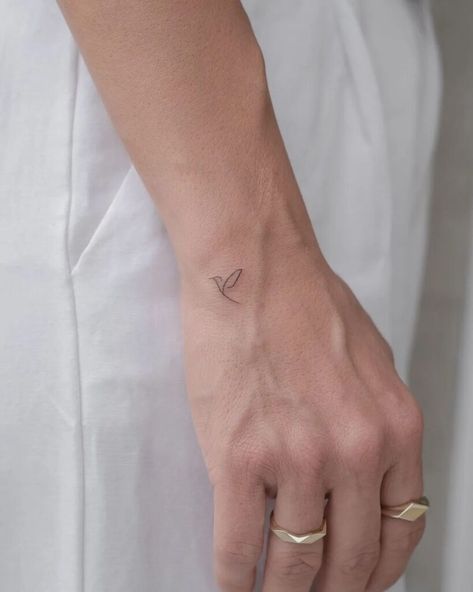 20 Small Tattoos With Deep Meaning And Powerful Symbolism Finger Tattoos Minimal, Minimal Bird Tattoos For Women, Subtle Bird Tattoos, Bird Hand Tattoos For Women, Line Art Hand Tattoo, Elegant Bird Tattoos, Single Angel Wing Tattoo, Bird On Hand Tattoo, Simple Bird Tattoos For Women