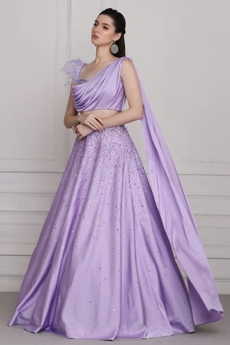 Buy Purple Draped Blouse And Skirt Set For Women by Pooja Peshoria Online at Aza Fashions. Drape Blouse Indian, One Side Sleeves Blouse Designs, Drape Gowns Designer Latest, One Side Sleeve Blouse, Feather Blouse Designs, Lavender Gown Indian, Drape Gowns Designer, Lavender Blouse Design, Pooja Peshoria