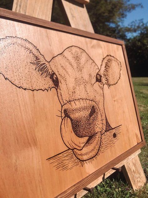 Framed wood burned sign of a cute cow with it's tongue out. KB Designs PNW. Wood work, epoxy, and custom wood burning designs for home, business and awesome handmade gifts. Wall decor, home decorations, nursery, wedding, wood pieces. Cow Wood Burning, Honey Ideas, Wood Burning Designs, Wood Burned Art, Wood Branding, Nursery Wedding, Wood Burned Signs, Woodburning Ideas, Wood Burn Designs