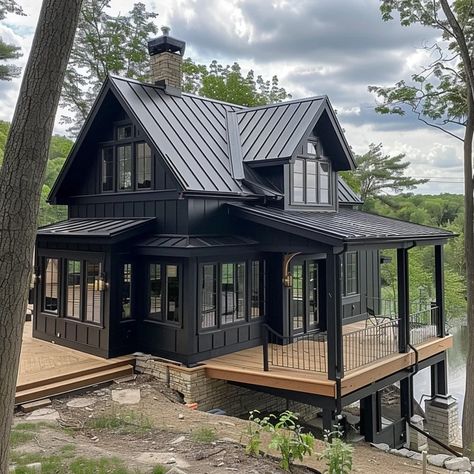 Image Dark Mountain Home Exterior, Black Houses With Wood Accents, Dark Lake House, Black Cabin Exterior, Black House With Wood Accents, Black Log Cabin Exterior, Black Lake House, Modern Log Cabins Exterior, Black Wooden House