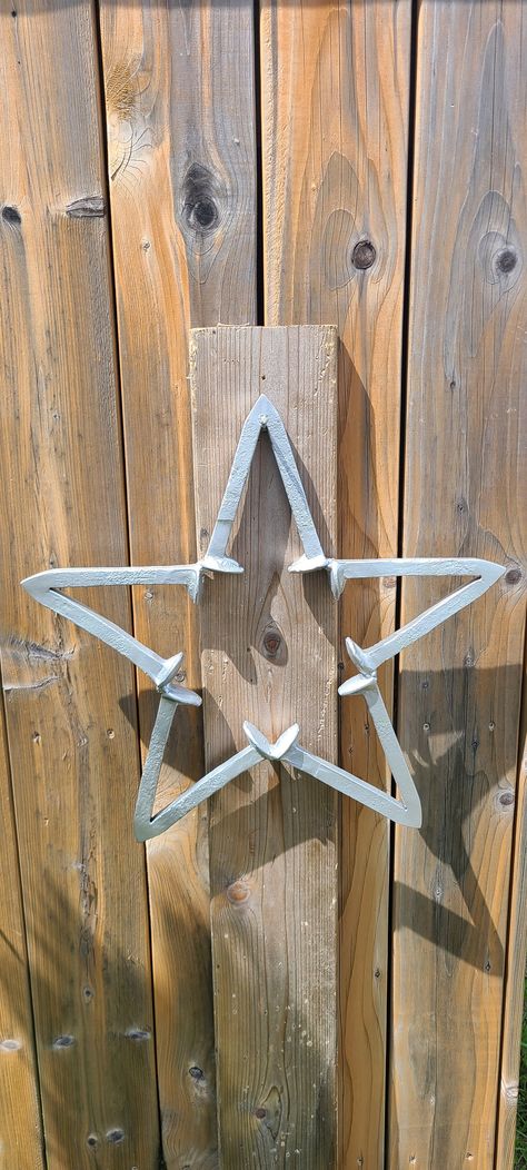 Handcrafted metal railroad spike star, made in Canada from locally reclaimed railroad spikes. They are painted silver and clear coated to last a long time in all conditions, perfect to hang on the side of your house or barn or anywhere you want. If you want a custom color message us and we can do that for an additional fee. They are approximately 18 by 18 inches and 2 inches thick. Metal Christmas Decor, Railroad Spikes Crafts, Railroad Spike Art, Forging Tools, Railroad Spikes, Flea Market Flip, Welding Art Projects, Horseshoe Crafts, Metal Welding