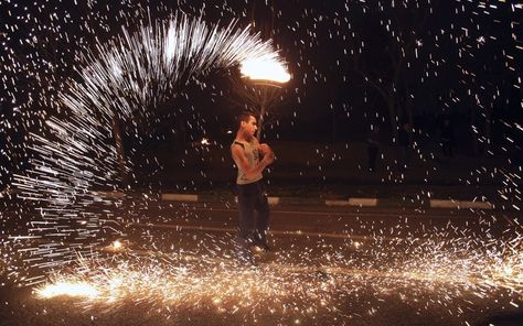 An Iranian man plays with a firework in the Pardisan Park in Tehran, Iran, during Chaharshanbe Souri, or Wednesday Feast, an ancient Festival of Fire, on the eve of the last Wednesday of the year, when Iranians jump over burning bonfires and throw firecrackers celebrating the arrival of spring. Persian New Year, Fire Festival, Tehran Iran, Persian Culture, Tehran, Online Photo Editor, Spring Cleaning, Fireworks, Iran