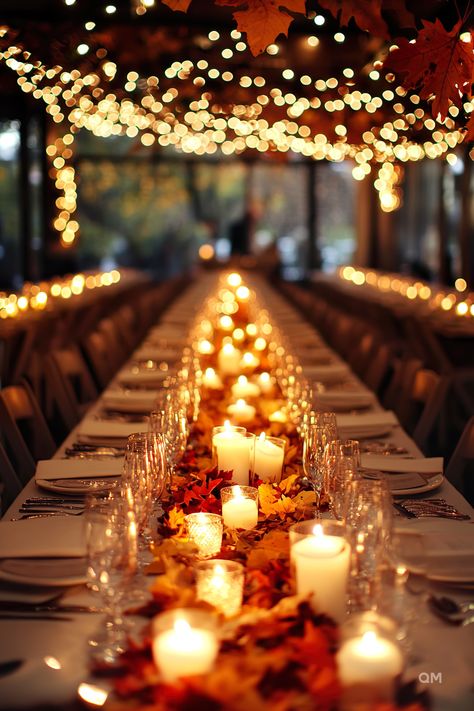 A long table adorned with fall candles, autumn leaves, and string lights creates an intimate setting for a stunning wedding in autumn. Fall Wedding Tables. November Wedding Indoor, Fall Wedding Memory Table, October Wedding Ceremony Decor, Small October Wedding, Wedding Theme Sunflowers, Fall Decorations Wedding, Elegant Fall Party, Fall Barn Wedding Ideas, Autumnal Party