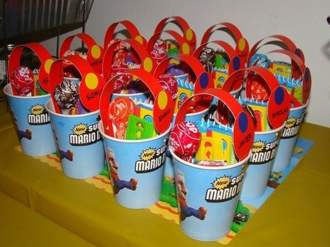 Brilliant - turn paper cups into buckets with addition of cardstock handles.  Cheap favor buckets Super Mario Party Favors, Super Mario Brothers Party, Mario Brothers Birthday Party, Mario Kart Party, Super Mario Bros Birthday Party, Super Mario Bros Party, Mario Bros Birthday, Mario Bros Party, Super Mario Birthday Party