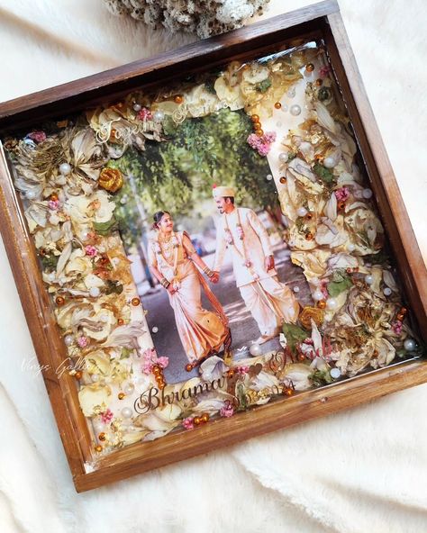 My client Abhishek wanted to gift his friends our trending frames and placed order for the frames as a post-marriage gift to the newly weds 🎁 Upon receiving fresh garlands immediately after the event, we could do proper drying of the flowers with utmost care & attention. This frame is really special , as I tried to incorporate cute elements to compliment the couples photo. And that's how the frame turned into 💕 This is one of the finest frames that I created and loved each bit of the pr... Resin Gift Ideas, Varmala Preservation, Resin Gifts, Fresh Garlands, Presents Birthday, Marriage Gift, Artist Birthday, Resin Artist, Framed Wedding Photos