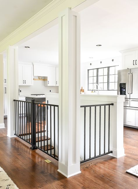 home with white craftsman style columns and black modern railing. #whitekitchen #ranchhome #rancher #craftsmancabinets #kitchendesign #openfloorplan #openconcept #openstairs Open Ranch Style Home, Stairwell In Kitchen, Stairs In Middle Of Kitchen, Open Concept Kitchen Living Room With Basement Stairs, Remodel Open Floor Plan Before And After, Kitchen With Stairs In Middle, Ranch House Open Basement Stairs, Small Ranch Renovation, Open Floor Plan With Stairs In Middle