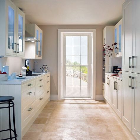 Glazed wall units Several design tricks have been used here. As well as simple clean lines of ivory cabinetry, an oven housing has been positioned near the door to stop it blocking light. Glazed wall units prevent a 'corridor effect' and allow for internal lighting, while integrated appliances keep the design sleek and uncluttered. Wren Kitchen, Galley Kitchen Design, Galley Kitchens, Cottage Shabby Chic, Glazed Walls, Galley Kitchen, Kitchen Design Ideas, Kitchen Redo, Counter Space