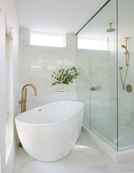 An oval freestanding bathtub is placed in a corner and paired with a brushed gold gooseneck tub filler fixed against marble floor tiles and in front of a marble tiled wall. Bathroom Freestanding, Small Bathtub, Giving Tree, House Bathrooms, Tub Ideas, Bathroom Redesign, Bathroom Tub, Freestanding Tub, Corner Shower