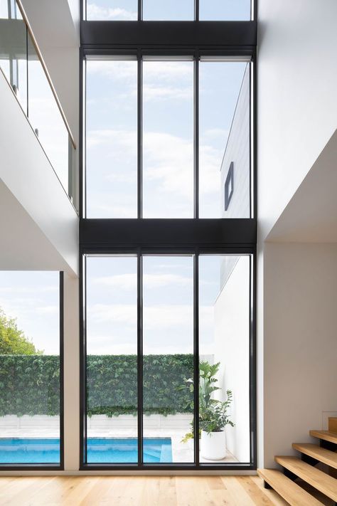 indoor outdoor connection through large windows in this modern house in Northcote, Melbourne designed by C. Kairouz Architects Void Design Interior, House With Big Glass Windows, Full Height Glass Window, Modern Glass House Design Big Windows Exterior, Clearstory Windows Modern, Double Height Crittal Windows, Double Height Glass Facade, Timeless House, High Windows