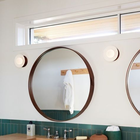 Understated sconces from Allied Maker paired with a simple walnut round mirror and a high transom window.  Love the simplicity. Decorating Mirror Ideas, Decorating Mirror, Globe Wall Light, Transom Window, High Windows, Shelter Design, Attic Bathroom, Bathroom Window, Builder Grade