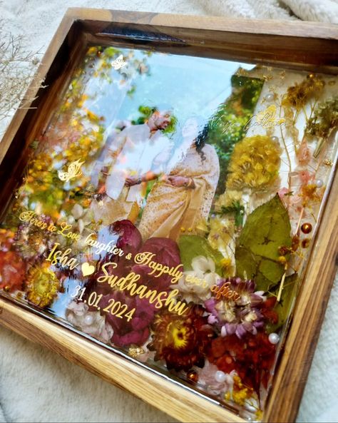 Looking for special gifts for newly weds?? You are in the right place ✨ My dad being a fan of trending teakwood frames asked me , could u create a photo frame as a wedding gift for a couple. And here it is! Crafted this beautiful vibrant yet elegant looking frame for a beautiful couple. And he absolutely loved the frame ❤️ Isn't it a special feeling when our family loves our work & supports us becoming a client ? 💞 Dm to order yours! #weddingframes #weddinginspiration #resinteakwoodframe ... Resin Art For Anniversary, Resin Art Frames For Couple, Resin Couple Gift Ideas, Wedding Gifts Ideas For Couple, Couple Photo Frame Ideas, Gifts For Newly Weds, Wedding Gifts Painting, Memory Diy, Photo Frame Wedding