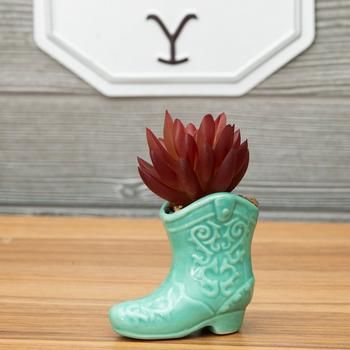 Dimensions: 4" H x 2.75" W x 2" D Material: Ceramic & Plastic Shape: Novelty Color: Teal, Red, White & Brown Orientation: Vertical Quantity: 1 Add some western flair to your space with this Succulent In Cowboy Boot Pot! This darling decoration features a tiny ceramic boot with embossed flourish details and a shiny turquoise glaze. Inside the boot are pebbles and a grape-red plastic succulent. Place it anywhere in your home or office for the cutest country accent. Western Desk Decor, Turquoise Office Decor, Boho Western Bedroom, Western Office Decor, Arizona Bedroom, Retro Western Aesthetic, Turquoise Office, Cactus Vase, Western Party Decorations