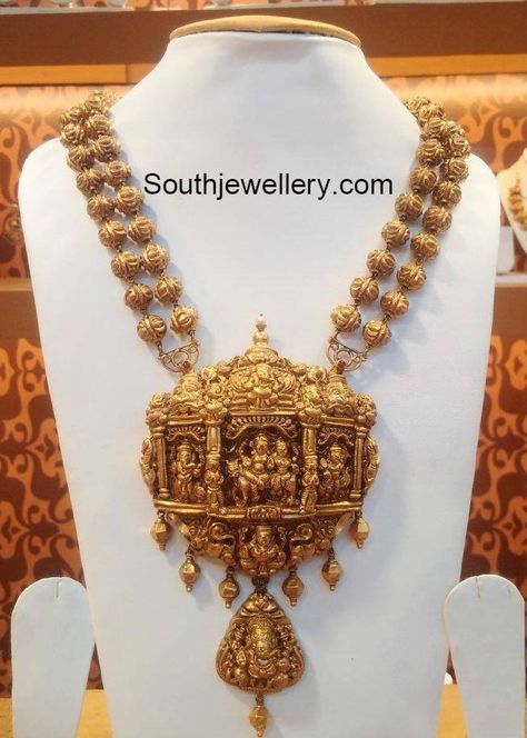 22 carat gold antique finish two line nakshi balls necklace featuring beautiful Nakshi work temple pendant embossed with Lord Shankar and Ganesh. For inquiries contact: Naj Jewellery, Nellore Email : mynaj@najindia.com Temple Jewelery, Rudraksha Jewelry, Latest Indian Jewellery, 22 Carat Gold Jewellery, Temple Jewelry Necklace, Gold Temple Jewellery, Antique Gold Jewelry Indian, Antique Jewellery Designs, Gold Necklace Indian Bridal Jewelry