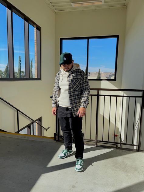 Fitted hat, cream hoodie, flannel, black slim pants, and green Nike Dunks. Green Nike Dunks, Hoodie Flannel, Black Slim Pants, Hat Cream, Cream Hoodie, Fitted Hat, Slim Pants, Go Green, Nike Dunks