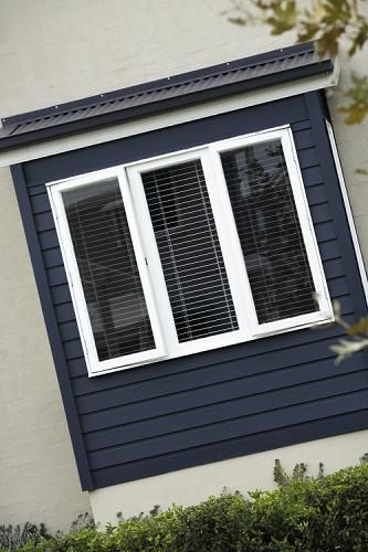 Weatherboard house with the same coloured boxed corners, white windows Navy Weatherboard House, Larch Cladding, Weatherboard House, House Colour, External Cladding, House Cladding, James Hardie, Beach House Exterior, House Colours