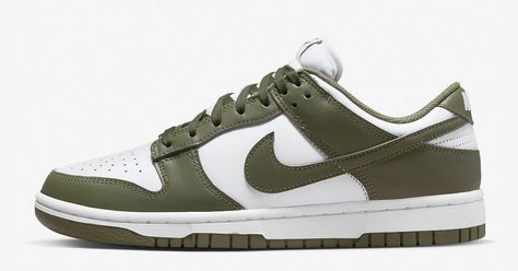 The Nike Dunk Low will now come in a “Medium Olive” colorway. With its white leather base and bright red overlays, this Dunk Low is a throwback to the classic two-tone Dunk look. However, as a lighter shade of olive green than the “Cargo Khaki,” the “Medium Olive” Dunk Low is an excellent option for those who liked the high-top version but preferred the low-top. The Nike Dunk Low Medium Olive is available in official photos. Nike.com and select retailers shoul Nike Dunks Olive Green, Nike Olive Green Shoes, Nike Dunk Low Medium Olive Outfit, Medium Olive Dunks Outfit, Nike Dunk Low Olive Green, Olive Dunks, Nike Dunk Low Medium Olive, Green Dunks, Womens Dunk Low