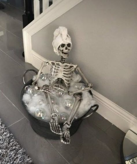 Ghost And Skeleton Decor, Skeleton Living Room Decor, Outdoor Apartment Halloween Decor, Skeleton Cauldron Bath, Med Spa Halloween Decor, Black Skeleton Decor, Skeleton In Tub With Bubbles, Skeleton Bubble Bath Diy, Skeleton Taking A Bath