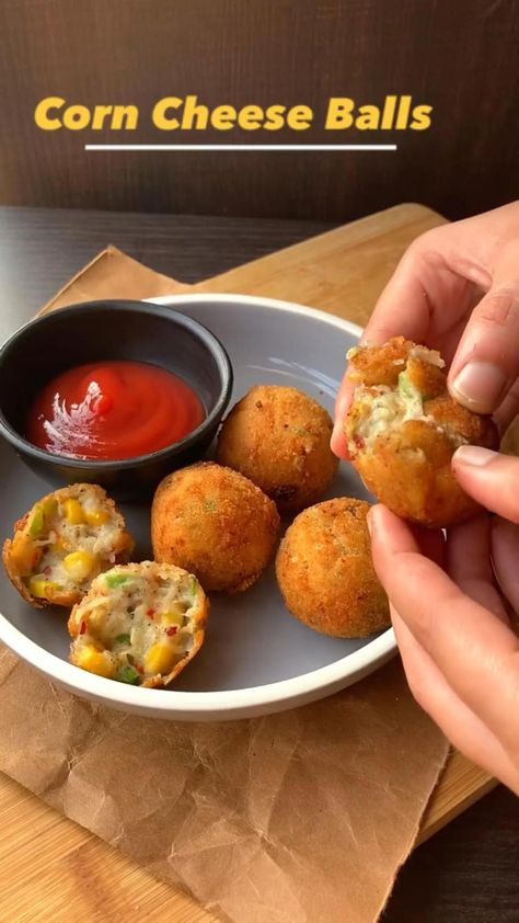 Corn Cheese Balls ✨What you need? For slurry:  • Flour - 1/2 cup • Water as required Salt For cheese ball mixture  • 1.Boiled potato - 2 big • 2.Cheese cubes - 2 grated  • 3.Cheese cubes - 2 ( cut into smaller cubes)  • 4.Capsicum- 1/2 cup ( chopped) • 5.Corn - 1/2 cup ( boiled) • 6.Black pepper - 1/2 tsp • 7.Chilli flakes - 1 tsp • 8.Oregano- 1 tsp • 9.Salt - as needed  • 10.Breadcrumbs - for coating 11.Oil - for frying What to Corn Cheese, Spicy Snacks Recipes, Iftar Recipes, Vegetarian Fast Food, Tastemade Recipes, Cheese Cubes, Vegetarian Snacks Recipes, Tasty Recipes Videos, Quick Recipes Snacks