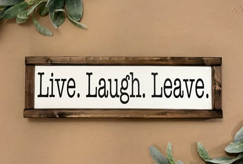 "Live Laugh Leave. This funny and sarcastic sign is the perfect entryway decor to make people laugh. Give as a gift or display in your own home! THIS SIGN: *Measures approximately 16\" x 5\" *Painted white with black lettering *Frame stained dark walnut  If you would like a variation in color or stain, please choose from the options pictured and add what you would like in the notes to seller section. Thank you for visiting Boards and Burlap. If you have an idea and would like to create a custom sign, please let us know. We would love to create something for you! IMPORTANT NOTICES: By submitting your order, you agree to all shop policies, thank you! 1. Our processing time varies seasonally, you can see our current processing time by checking the \"shipping & policies\" tab located in this l Live Laugh Love Quotes Funny, Entryway Signs Quotes, Funny Entryway Signs, Sayings For Signs Home Decor, Funny House Signs, Funny Home Signs, Funny Chalkboard Signs, Sassy Welcome Signs, Funny Signs For Home Hilarious