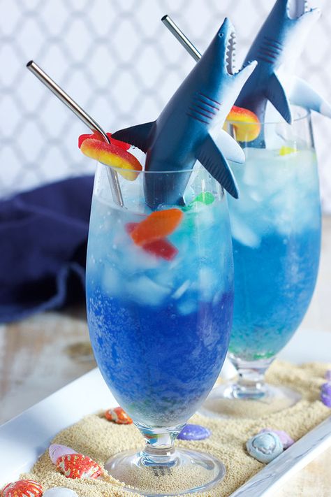 A kid-friendly cocktail that's easy to make, this Shark Attack Cocktail recipe is as fun to make as it is to drink. The shark is filled with a "bloody" surprise...just in time for shark week or any shark themed birthday party. | @suburbansoapbox Shark Week Drinks, Shark Week Recipes, Shark Themed Birthday, Shark Week Party, Kid Friendly Drinks, Birthday Cocktail, Shark Themed Birthday Party, Shark Bait, Shark Cake