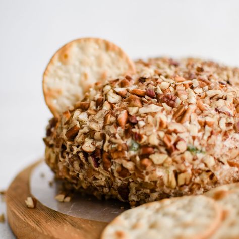 This Pineapple Cheese Ball is the retro party appetizer you've been searching for! Made with cream cheese, crushed pineapple, cheddar cheese, green bell pepper, green onions, and chopped pecans, its balance of sweet and savory flavors makes it the perfect addition to any party or gathering! Cheese Ball Recipes With Pineapple, Cheeseball With Pineapple, Cheese Ball With Pineapple, Pineapple Cheeseball Recipes, Pineapple Cheeseball, Party Snacks Easy Appetizers, Pineapple Cheese Ball, Pineapple Fluff, Pineapple Cheese