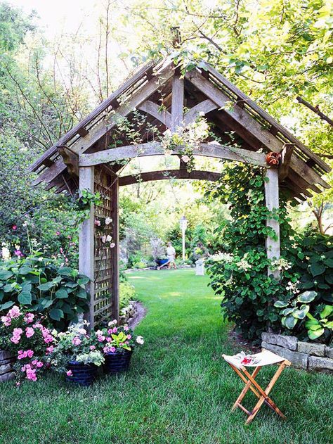 An arbor serves as a beautiful portal to a backyard garden. This large arbor features posts that are 6x6 lumber--large enough to support any climbing plant. The lattice sides and top provide crawling space for flowering climbers such as roses or clematis. Side House Garden, Garden Archway, Garden Vines, Garden Arbor, Garden Arches, Garden Entrance, Small Garden Design, Garden Trellis, Garden Structures