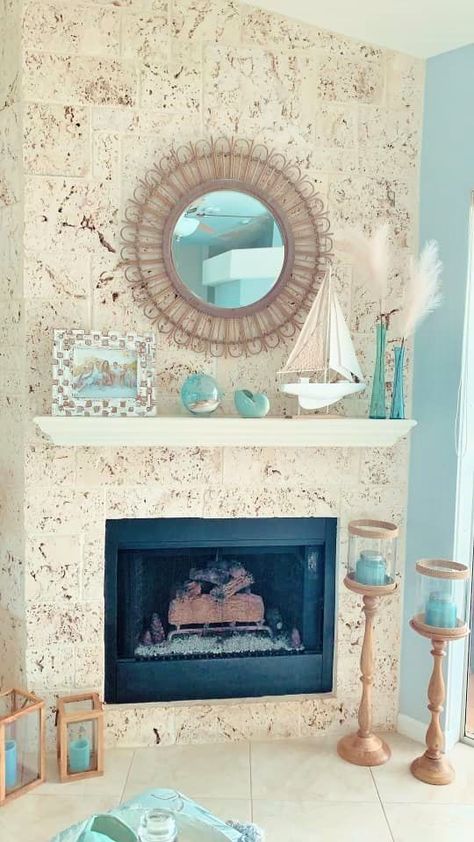 a gorgeous coastal mantel with a buoy, an aqua faux seashell, aqua vases with pampas grass, a boat and a family pic plus aqua candles around Vases With Pampas, Coastal Mantle, Beach House Fireplace, Coastal Mantle Decor, Beach Fireplace, Coastal Fireplace, House Fireplace, Mantel Decor Ideas, Beach Theme Living Room