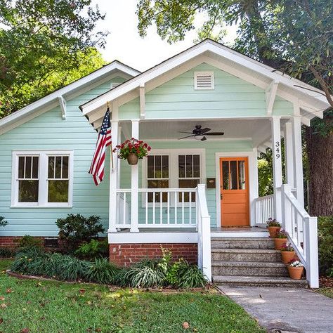 Exterior House Colors Bright, Light Blue Bungalow Exterior, Orange Front Door Blue House, Light Orange House Exterior, Bright Colored Houses Exterior, Light Orange Front Door, Light Blue House Front Door Color, Mint House Exterior, Yellow Siding Color Schemes Exterior