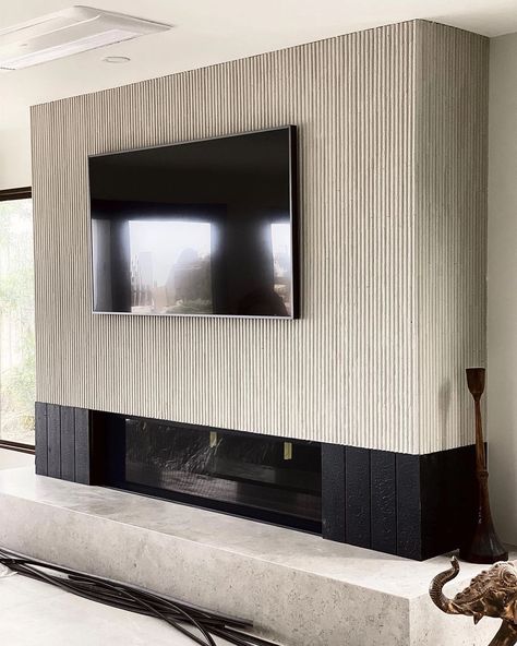 Reeded Fireplace Wall, Fluted Tile Fireplace, Slated Wall Fireplace, Modern Linear Fireplace, Fluted Wood Panel Fireplace, Fluted Linear Fireplace, Black Fluted Fireplace Wall, Wood Slat Fireplace Wall, Basement Fireplace