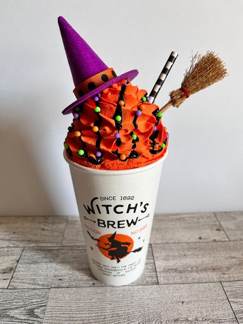 This listing is for ONE Fake Witches Brew Latte with a purple hat! This adorable witches brew latte is perfect for Halloween Decor, Kitchen Decor, Tier Trays, party decor or as a gift! This Witches Brew Latte is topped off with a witches broom, purple hat, and spooky drizzle and fake sprinkles! Each item is handmade so no two lattes are exactly the same. Because each item is handmade, processing time is 5-7 days. *Tier trays, signs, and accessories NOT included *This item is FAKE, DO NOT EAT *Ti Halloween Fake Bakes, Marshmallow People, Halloween Witches Brew, Boo Bash, Witches Broom, Fake Sprinkles, Fake Bakes, Fake Cupcakes, Faux Food