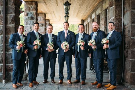 From the start, Jon knew that he wanted his groomsmen in tailored navy suits with brown shoes. The sartorial decision, as well as the waterfront locale, set the tone for the rest of the decor, leading Katherine to select a color palette of navy blue, sage green, peach and gold. Navy Suit Sage Tie, Sage Tie Wedding, Navy Suit Brown Shoes, Male Suits, Groomsmen Outfit, Sage Green Tie, Navy Suits, Grooms Men, Groom And Groomsmen Suits