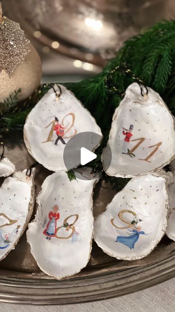 Ellen on Instagram: "I love the organic shapes of Oyster shells and these ornaments are so easy to make even last minute as place cards for the table setting. Any printed tissue paper will work or print your own as I did with the 12 days of Christmas. I’ll share the link to that clip art in stories. 🌲 Instructions: 1. Wash shells 2. Paint inside with pearlized craft paint, let dry 3. Apply modge podge, I used satin 4. Apply tissue design (if covering entire shell you’ll need to trim) 5. Cover entire inside of shell over tissue with modge podge let dry 6. I like to use gold guilding paint to edge the shell and go over any details like the numbers on the 12 days of Christmas Lastly I hit glued ribbon on the blue ones and on the 12 days of Christmas I glued a jewelry finding and strung t Scallop Shell Christmas Ornaments, Oyster Shell Nativity Ornament, Decoupage Shell Ornaments, Clam Shell Decoupage, She’ll Christmas Ornaments, Oyster Shells, 12 Days Of Christmas, Tissue Paper, Thing 1 Thing 2