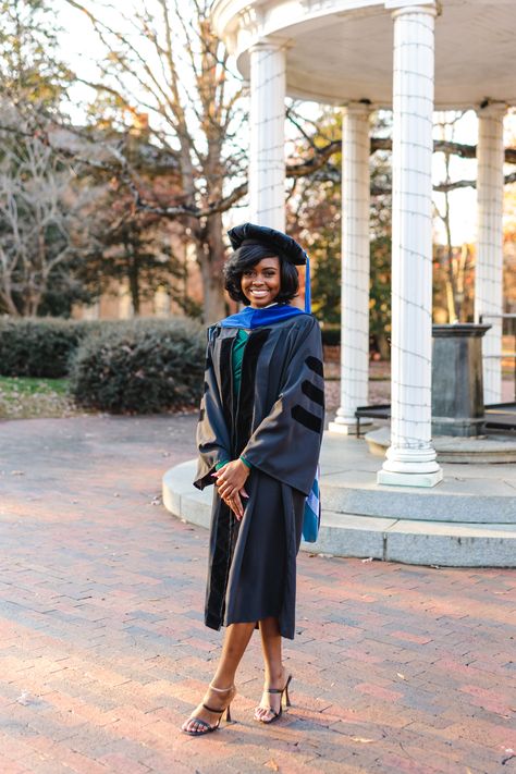 Young woman in graduation regalia Doctoral Graduation Dress, Phd Graduation Pictures, Phd Convocation, Doctoral Graduation Pictures, Graduation Photoshoot Doctorate, Phd Graduation Photos, Cap And Gown Outfit, Doctorate Graduation Pictures, Graduation Doctorate