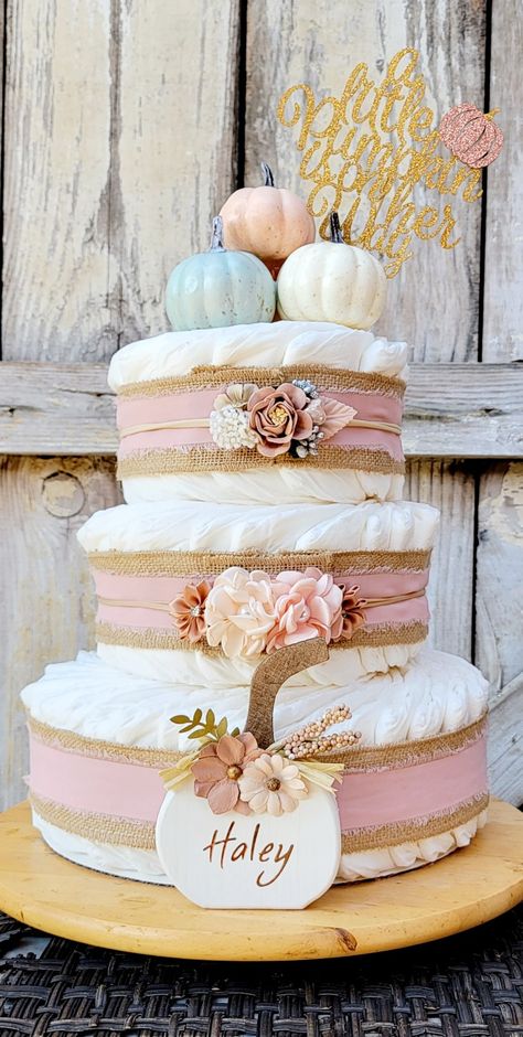 Fall Candy Bar Ideas, Fall Pink Baby Shower Ideas, Diaper Cake Pumpkin Theme, Diaper Cake Fall Theme, Pink Pumpkin Shower Ideas, Pink Pumpkin Baby Shower Centerpieces, Baby Girl Baby Shower Themes Fall, Fall Baby Shower Diaper Cakes, Pumpkin Baby Shower Cake Girl